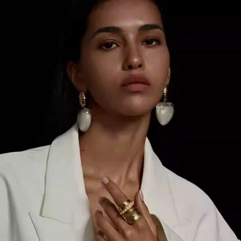 Woman wearing large heart-shaped earrings