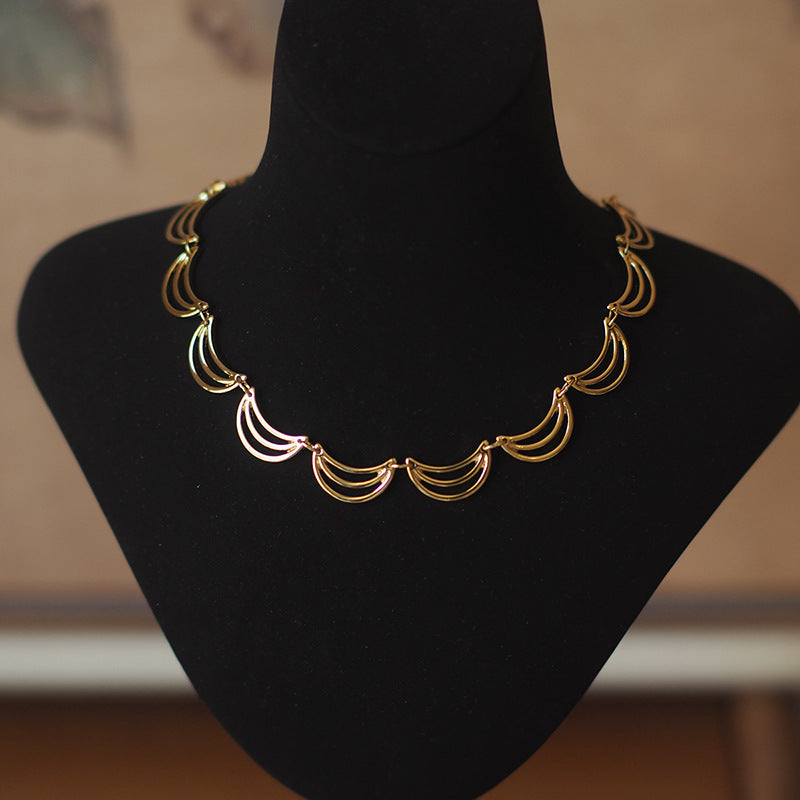 Gold necklace with banana/moon shape details
