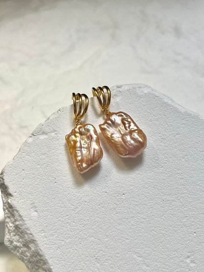 Gold earrings with peach pearls for wedding guest