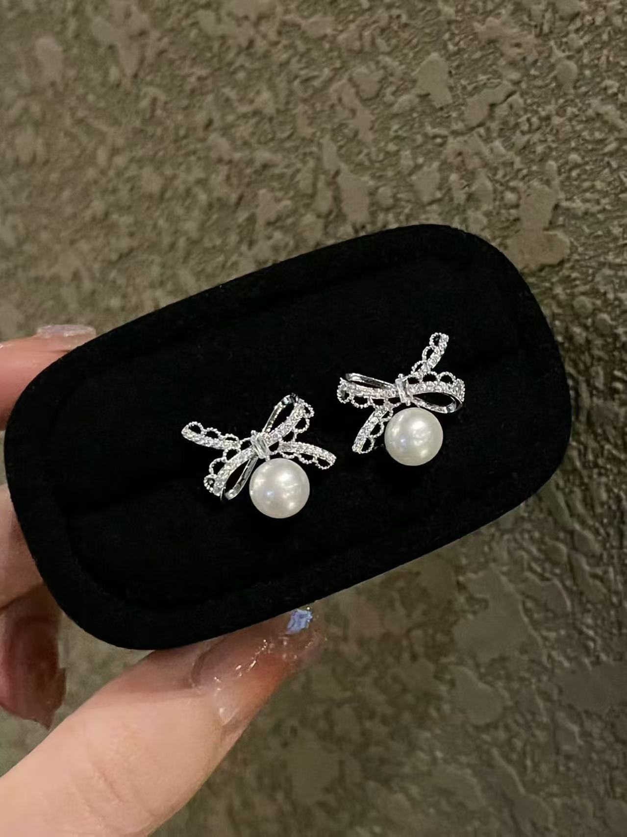 Pearl and silver bow earrings