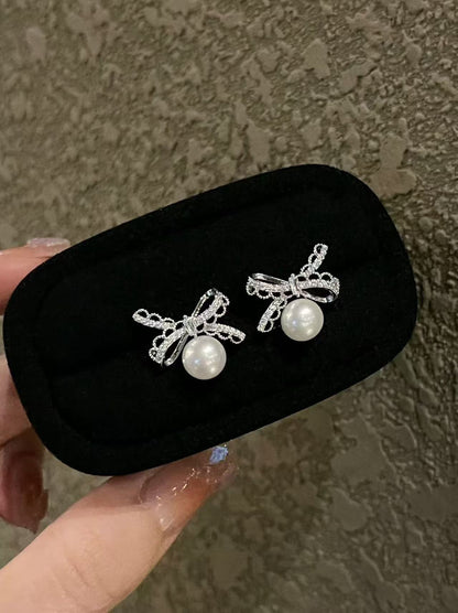 Pearl and silver bow earrings