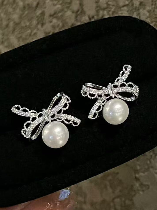 Pearl and silver bow earrings