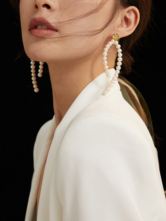 Woman wearing large pearl earrings 
