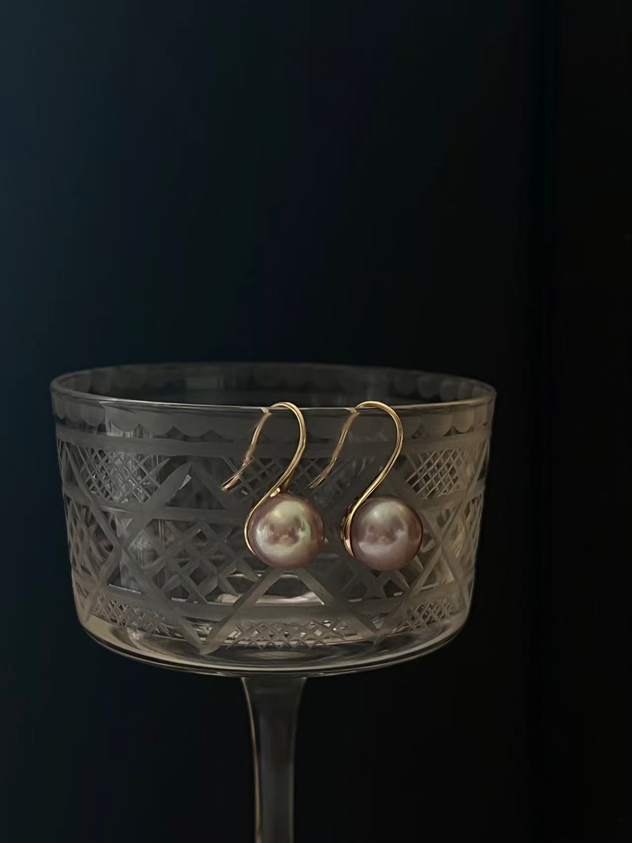 Purple pearl drop earrings on-ear example