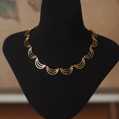 Gold necklace with banana/moon shape details