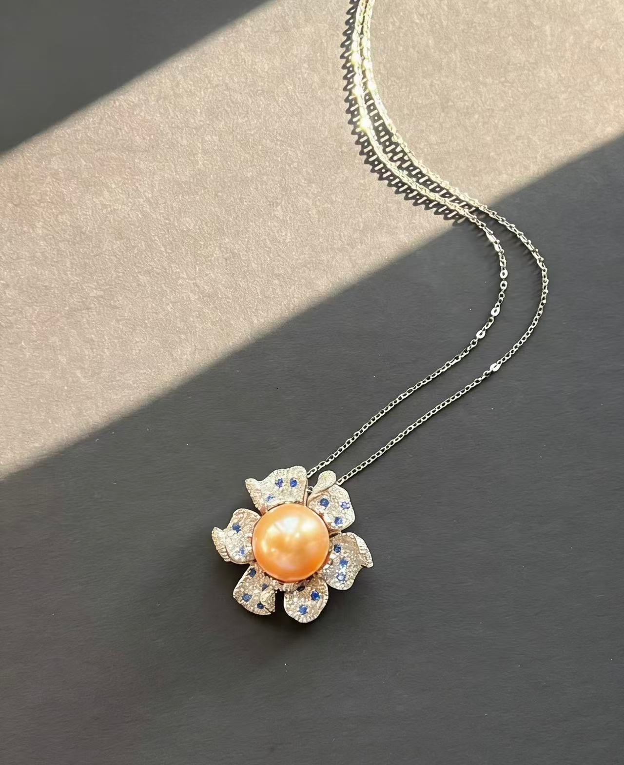 Necklace with a floral pendant featuring a central pearl for mother of the bride